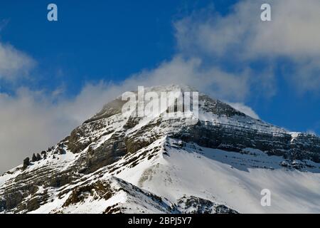 A close up image of a rocky mountain peak with snow in rural Alberta Canada. Stock Photo