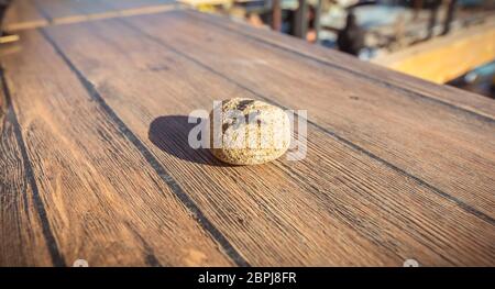 figure 4 written in felt on a small stone on the table of a restaurant Stock Photo