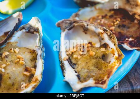 dish of oysters and mussels cooked and raw on a table near the sea in the south of France Stock Photo