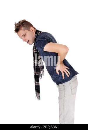 A slim young man standing and holding his back for heavy pain with a scarf around his neck, isolated for white background Stock Photo