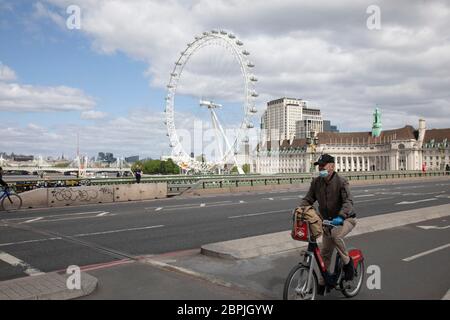 Westminster Bridge looking towards the London Eye, is eerily quiet, devoid of traffic, and silent on empty streets as lockdown continues and people observe the stay at home message in the capital on 11th May 2020 in London, England, United Kingdom. Coronavirus or Covid-19 is a new respiratory illness that has not previously been seen in humans. While much or Europe has been placed into lockdown, the UK government has now announced a slight relaxation of the stringent rules as part of their long term strategy, and in particular social distancing. Stock Photo