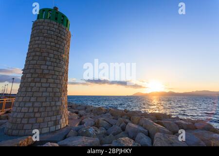 Sunset from the port of Cannes, France. Beautiful french panorama. Sun over Esterel mountains Stock Photo