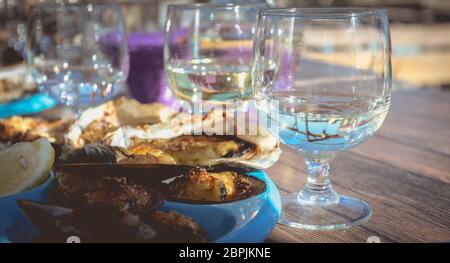 dish of oysters and mussels cooked and raw on a table near the sea in the south of France Stock Photo