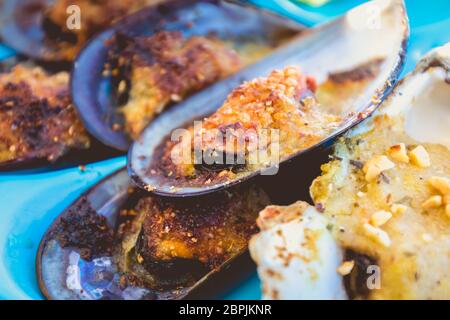 dish of oysters and mussels cooked and raw on a table near the sea in the south of France Stock Photo