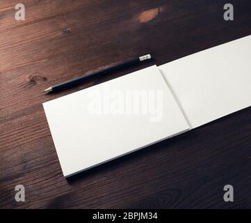 Blank horizontal brochure and pencil mock up on wooden background. Stock Photo