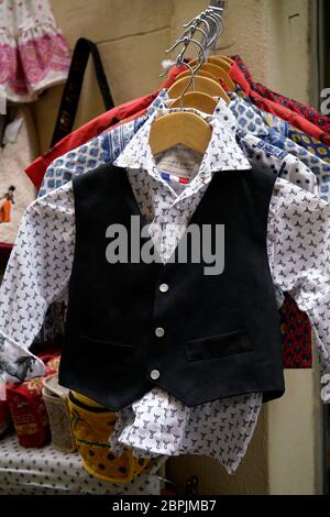 Children's dress shirts with vest for sale outside of a souvenir store.Arles.France Stock Photo