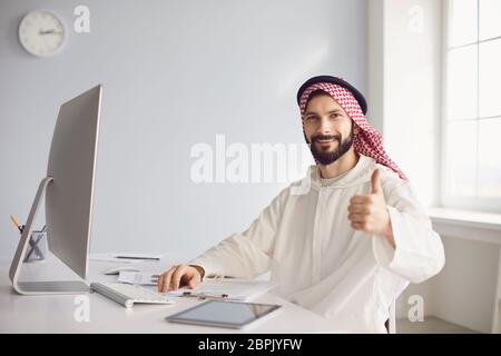 Arab businessman worker works in computer on the workplace in the office. Stock Photo