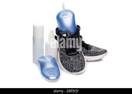 Sports Shoes Care. Electric Shoes Dryer With UV Sterilization On A Black  Background, Deodorant For Shoe And Antifungal Agent. Shoe Care Products.  Concept Of Healthy Feet. Fitness And Sport Footwear Stock Photo