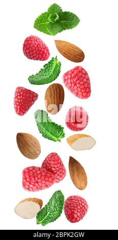 Flying fresh raspberry, almonds and mint leaves isolated on white background with clipping path as package design element and advertising. Full depth Stock Photo