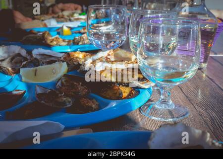 dish of oysters and mussels cooked and raw on a table near the sea in the south of France Stock Photo