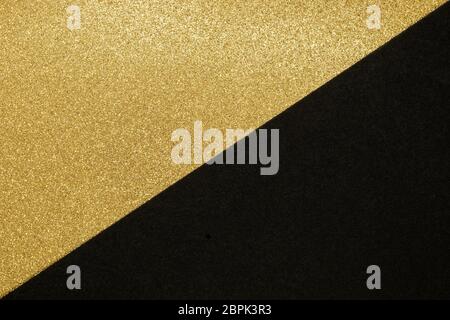 Abstract background of golden shiny and black craft paper split in the half make triangle shape Stock Photo