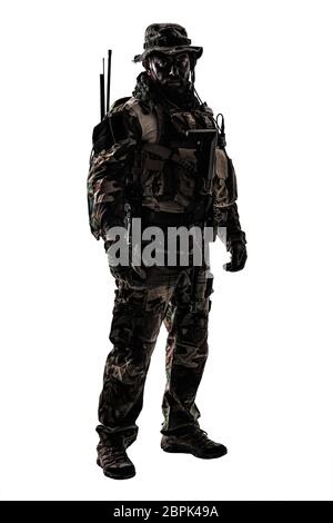 Special forces United States in Camouflage Uniforms studio shot. Holding weapons, wearing jungle hat, Shemagh scarf, painted face, his outfit clothes Stock Photo