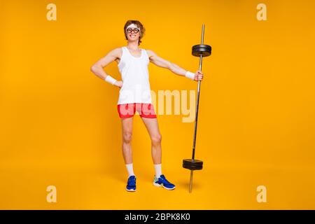 Full length body size view of his he nice attractive cheerful cheery content slim thin fit sportive guy holding in hand heavy barbell isolated over Stock Photo