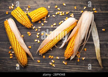 Corn cobs and seeds on wooden table. Top view Stock Photo