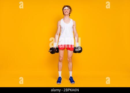 Full length body size view of his he nice attractive cheerful cheery slim thin guy sportsman doing work out holding in hand barbell isolated over Stock Photo