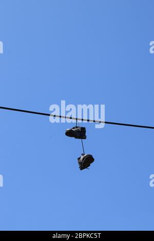 shoes on a wire Stock Photo