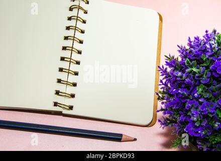 Top view with copy space, Blank notebook, pencil and tree in pots on background Stock Photo