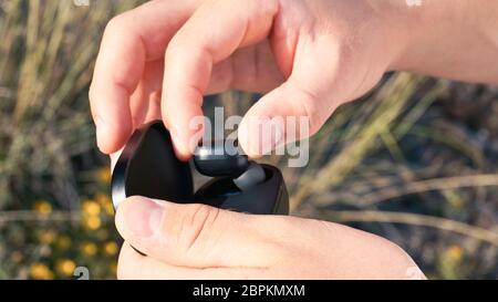 Black compact headphones in young hands close up Stock Photo