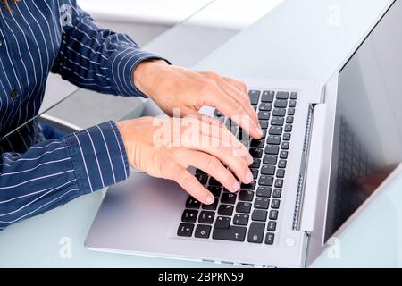 business womans hands on computer keyboard Stock Photo