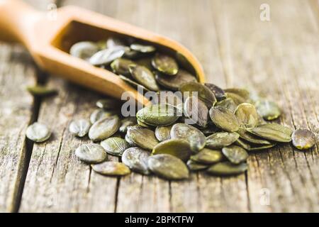 Download Peeled Pumpkin Seeds In A Wooden Bowl Stock Photo Alamy PSD Mockup Templates