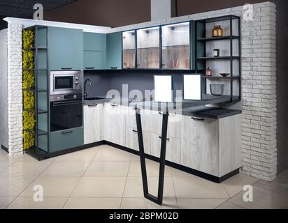 Two blank mockup book brochure catalog on stoneware countertop with advertising copyspace over out of focus upscale Aqua Menthe kitchen in luxury home Stock Photo