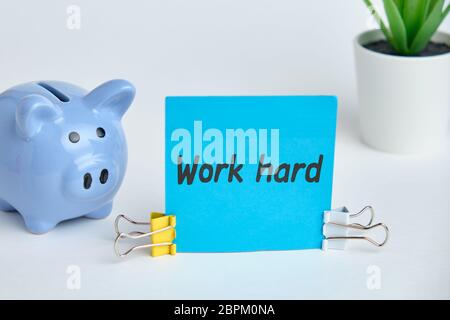 Hand lettering on the sticker work hard on a white background. Close up. Stock Photo