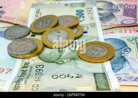 Piles of currency Indian Rupees in notes and coins in different denominations. Save money for the future. d old coins. Saving money and account financ Stock Photo
