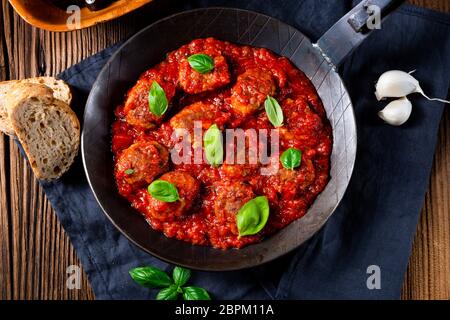 Baked mini meatballs in tomato sauce with basil Stock Photo