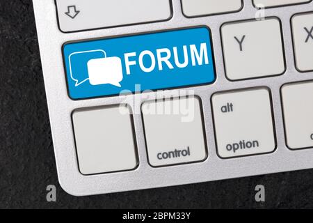 Keyboard in Detail with graphic shows a logo with two speech bubbles and the word Forum Stock Photo