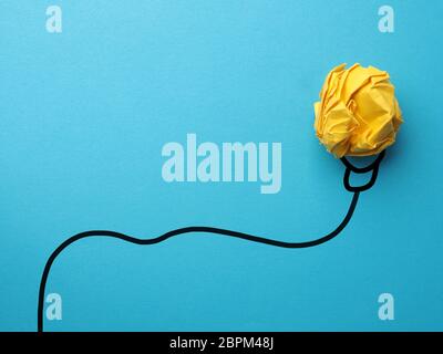 Creativity concept with crumpled yellow paper Stock Photo