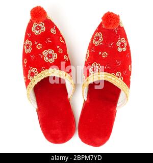 Red embroidered Turkish slippers, decorative footwear isolated on white background, top-down view Stock Photo