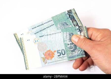 three 50 Malaysian Ringgit banknotes in the hand Stock Photo