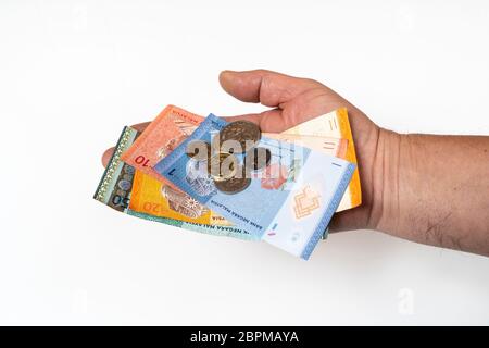 some Malaysian Ringgit banknotes and coins in the hand Stock Photo