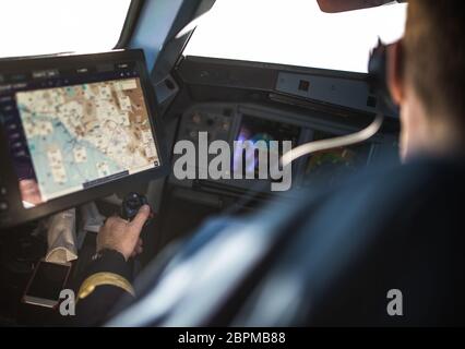 Pilot's hand accelerating on the throttle in  a commercial airliner airplane flight cockpit during takeoff Stock Photo