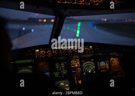 Pilot's hand accelerating on the throttle in  a commercial airliner airplane flight cockpit during takeoff Stock Photo