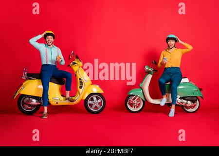 Full length body size view of nice attractive amazed cheerful friends friendship sitting on moped using web service app great feedback like isolated Stock Photo