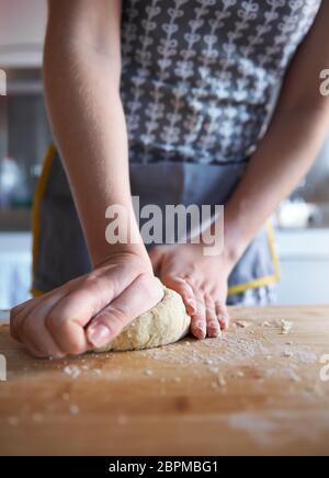 Anonymous Woman making fresh dough at home in her kitchen, close up frame. Stock Photo