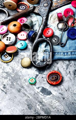 Composition with threads and sewing accessories.Sewing threads, fabric and buttons Stock Photo