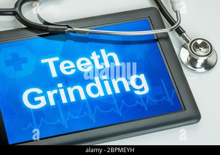 Tablet with the text Teeth grinding on the display Stock Photo