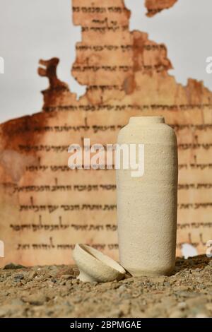 A model of a Jar used for the Dead Sea scrolls against a blurred background of the Isaiah scroll Stock Photo