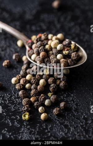 Different types of dried peppercorn in spoon. Stock Photo