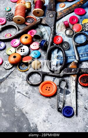 Composition with threads and sewing accessories.Sewing threads, fabric and buttons Stock Photo