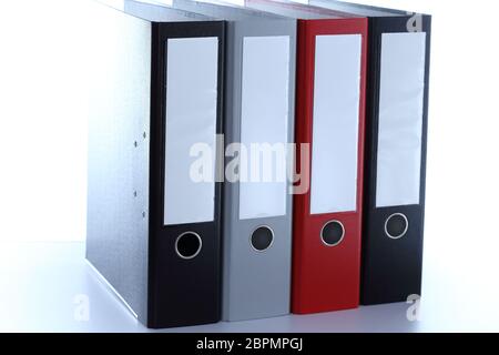 some file folders in row on a desk Stock Photo