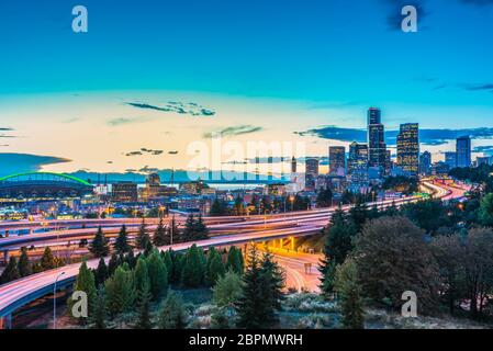 Seattle skylines and Interstate freeways converge with Elliott Bay and the waterfront background of in sunset time, Seattle, Washington State, USA.. Stock Photo