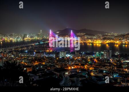 Busan harbor bridge is one of famous bridges in south korea. Connecting Yeongdo and Nam district, the bridge lits up at night in different colors. Tak Stock Photo