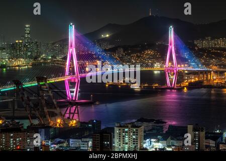 Busan harbor bridge is one of famous bridges in south korea. Connecting Yeongdo and Nam district, the bridge lits up at night in different colors. Tak Stock Photo