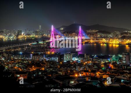 Busan harbor bridge is one of famous bridges in south korea. Connecting Yeongdo and Nam district, the bridge lits up at night in different colors. Tak Stock Photo