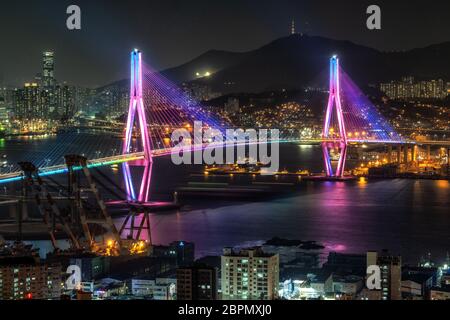 Busan harbor bridge is one of famous bridges in south korea. Connecting Yeongdo and Nam district, the bridge lits up at night in different colors. Tak Stock Photo