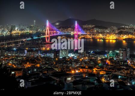 Busan harbor bridge is one of famous bridges in south korea. Connecting Yeongdo and Nam district, the bridge lits up at night in different colors. Tak Stock Photo