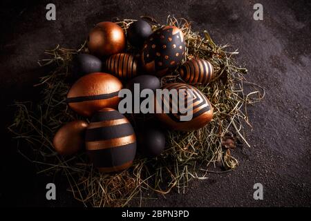 Easter golden and black eggs with geometric pattern on dark background Stock Photo